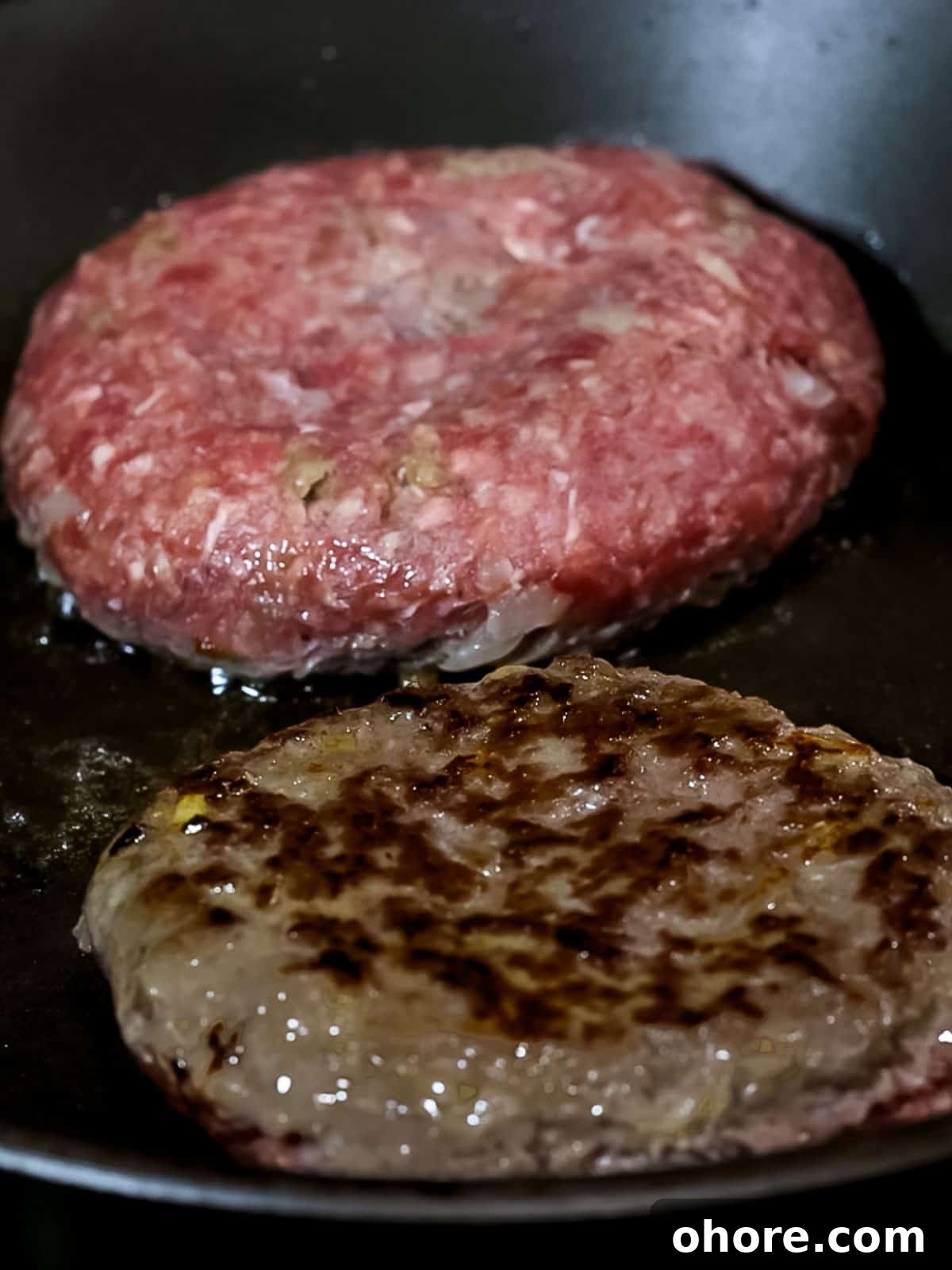 Japanese Hambagu (Hamburger Steak) Recipe — Authentic Pan-Fried Steak 11 Japanese hamburger steak patties cooking in a pan with golden brown edges.
