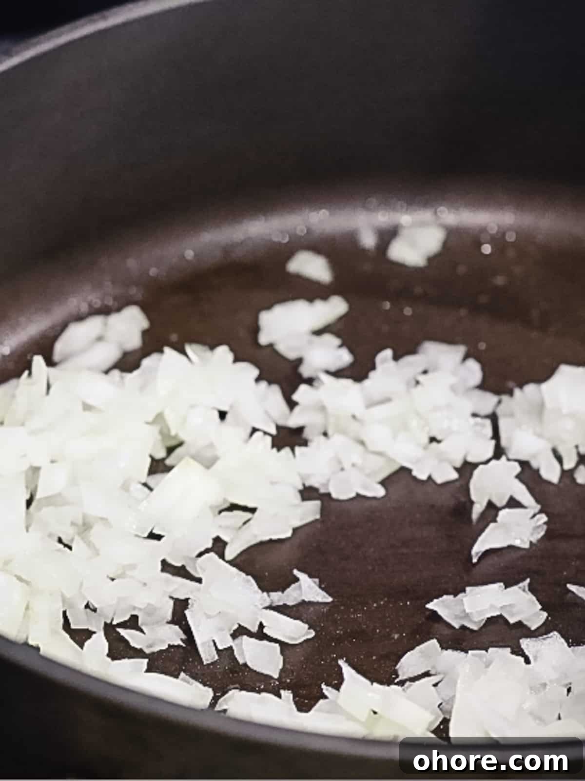 Japanese Hambagu (Hamburger Steak) Recipe — Authentic Pan-Fried Steak 7 Diced white onions being sauteed in a pan.