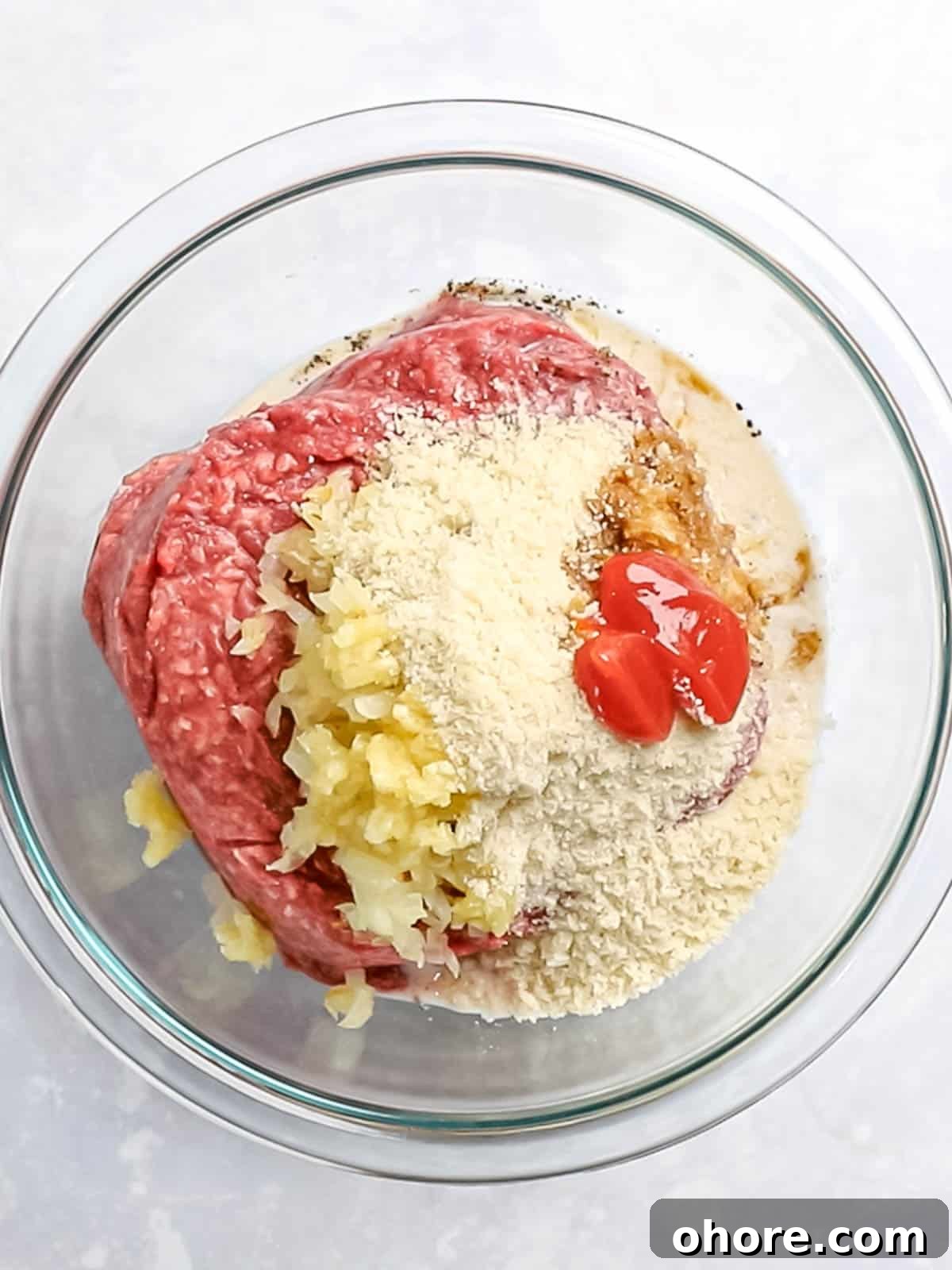 Japanese Hambagu (Hamburger Steak) Recipe — Authentic Pan-Fried Steak 8 Ground beef, panko, onions, and ketchup in a glass bowl.