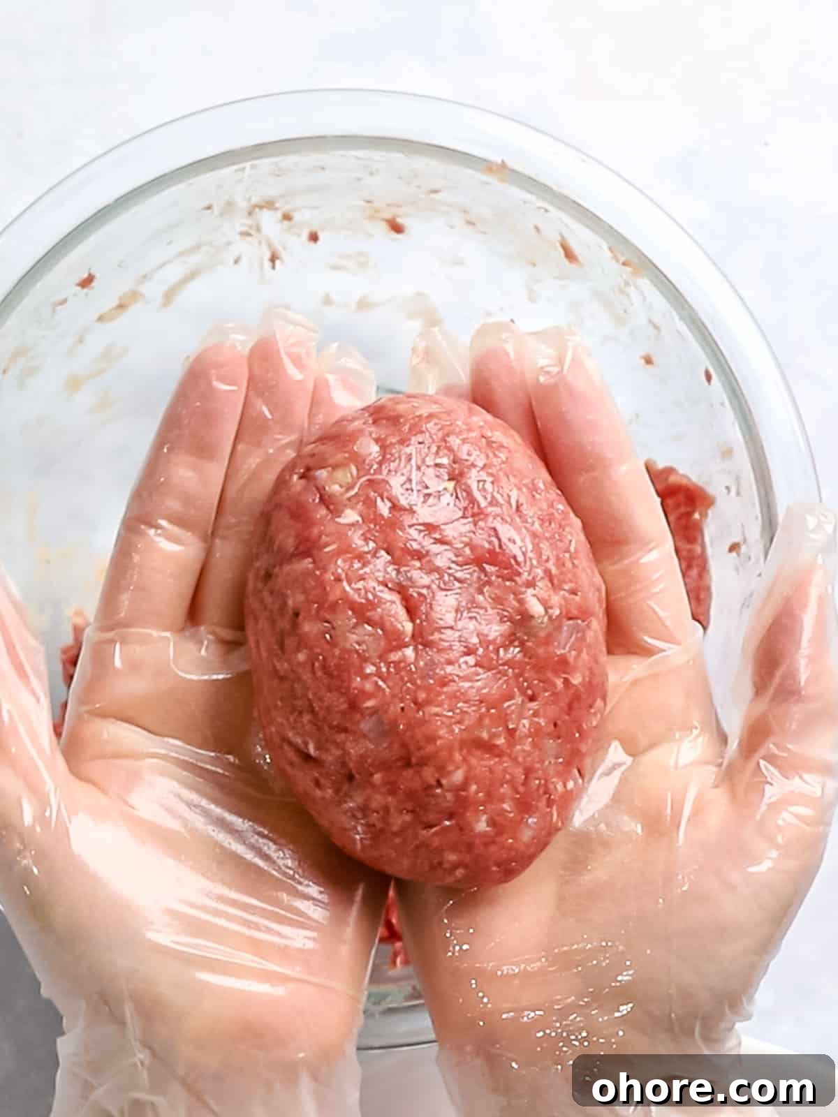 Japanese Hambagu (Hamburger Steak) Recipe — Authentic Pan-Fried Steak 10 Hambagu patty of ground meat formed into a round oval shape and held in hands.