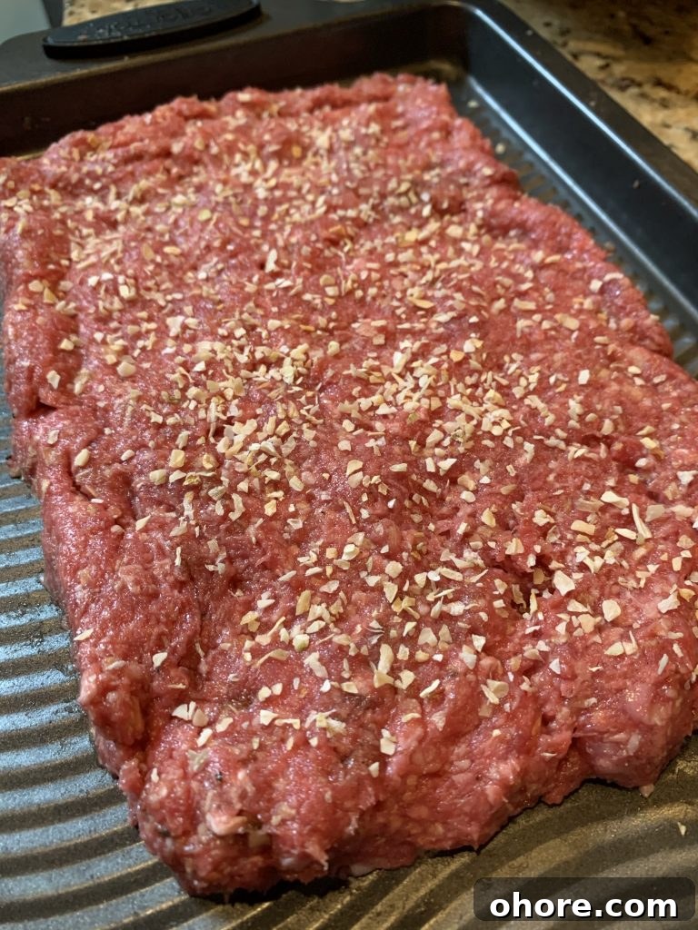 Mini Big Mac-Style Cheeseburgers Recipe 4 Ground meat formed into a large beef patty with onion flakes on top