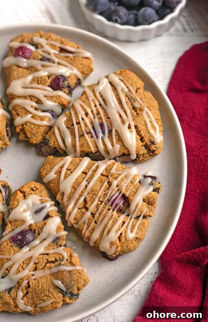 Paleo Blueberry Scones Recipe – Flaky, Grain-Free Breakfast Treat 2 a plate of paleo blueberry scones