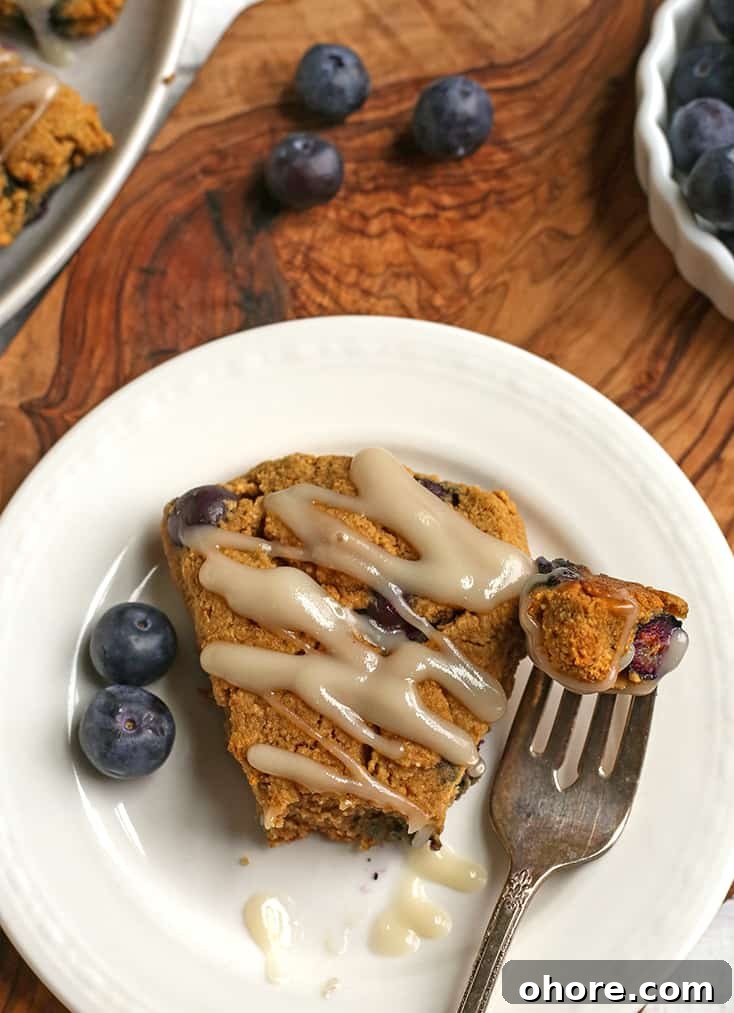 Paleo Blueberry Scones Recipe – Flaky, Grain-Free Breakfast Treat 4 paleo blueberry scone on a plate