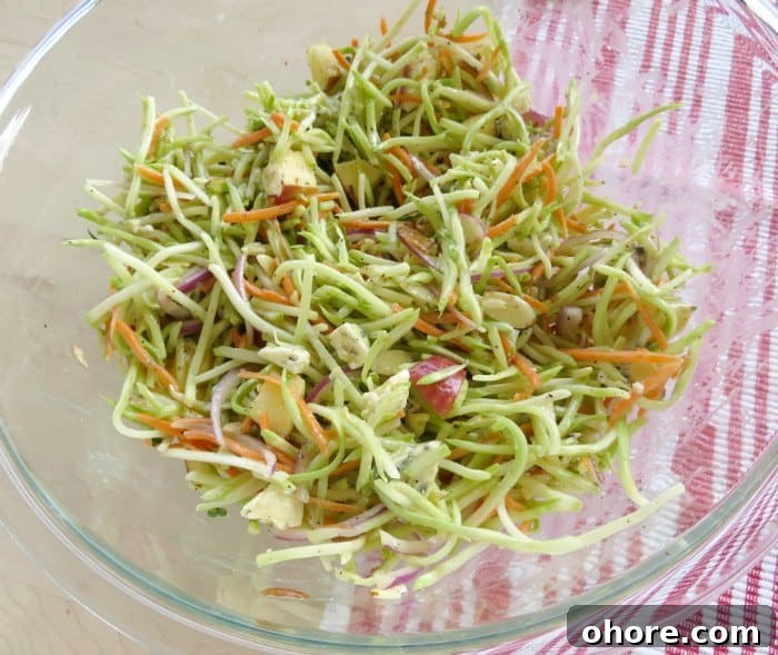 Quick Broccoli Slaw Recipe You Can Make Tonight 6 broccoli slaw in a glass bowl next to a red cloth napkin