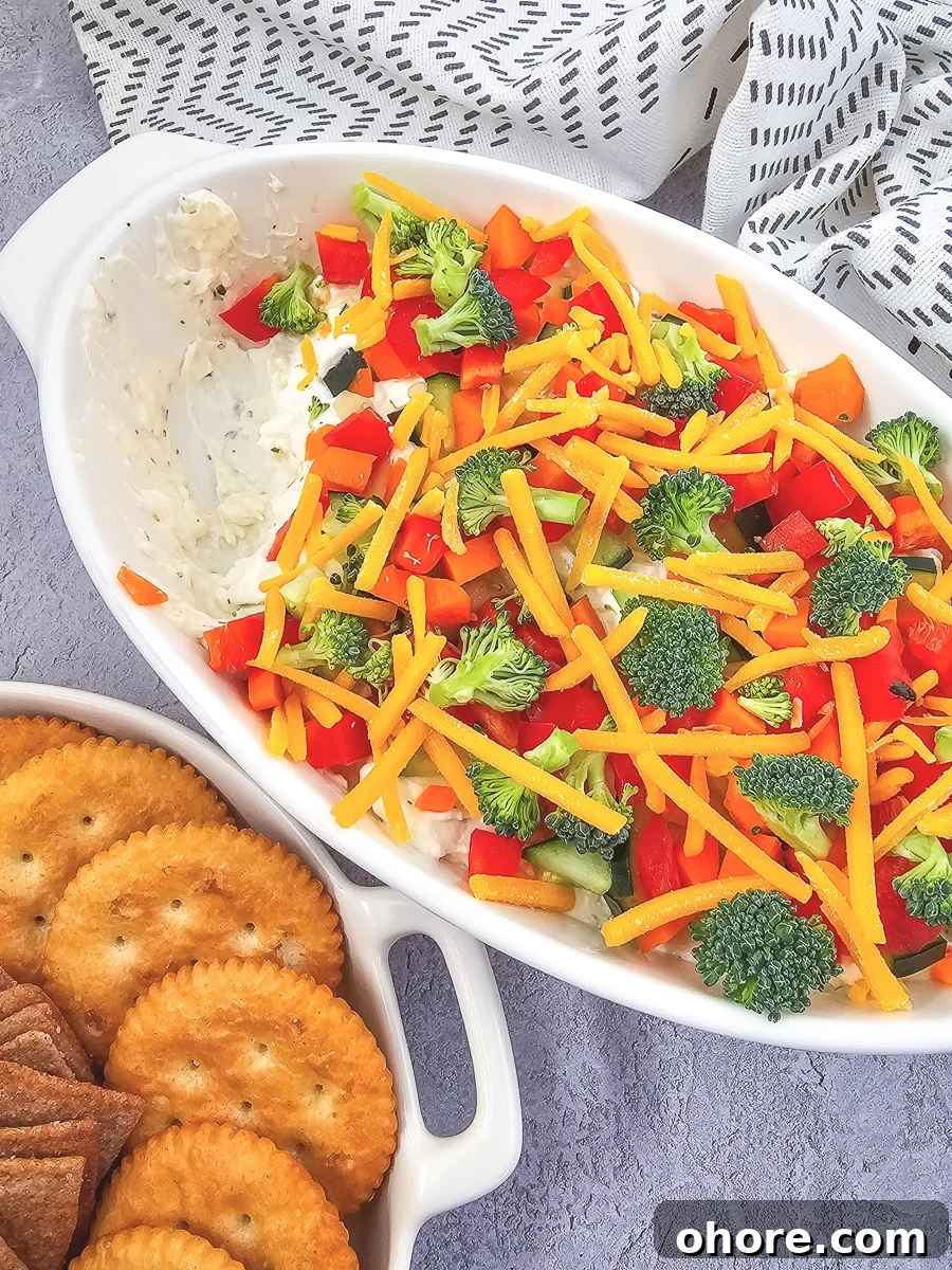 Creamy Vegetable Pizza Dip Recipe for Parties and Game Day 2 Veggie pizza dip in a white bowl.