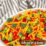 Creamy Vegetable Pizza Dip Recipe for Parties and Game Day 11 Vegetable pizza dip in a white serving dish.