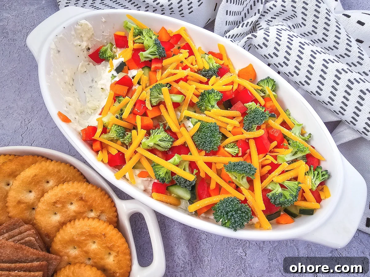 Creamy Vegetable Pizza Dip Recipe for Parties and Game Day 5 Overhead view of veggie pizza dip in a white bowl.