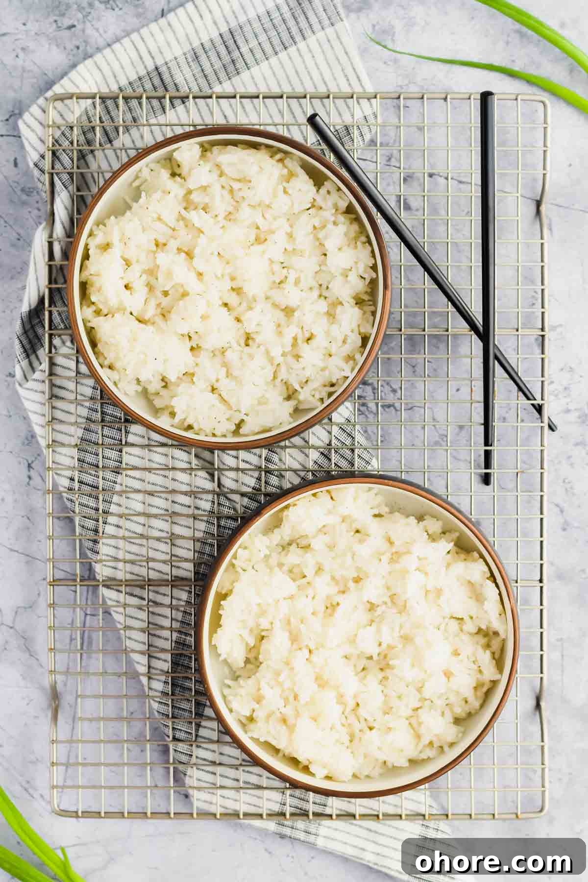 California Roll Bowl Recipe: Sushi-Inspired Deconstructed Bowl Guide 4 two bowls of rice on silver rack and concrete background.